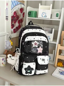 Detail shot of the Japanese cute black and white star backpack with clear pocket and plush charm.