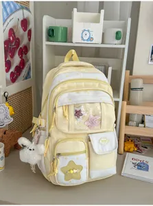 Close-up detail of the cute yellow star backpack featuring clear front pocket and bunny charm.