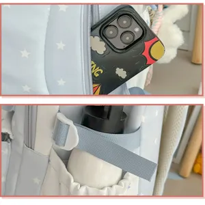 Detailed view of cute star pattern school backpack, showing front zipper and side holder.