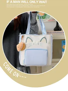 Cute canvas tote bag with cat face design, large capacity casual shoulder bag for daily use.
