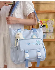 Cute blue canvas tote shoulder bag with cat ears and fluffy pendant for students casual daily use.