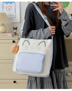 Detail shot of the cute cat design color block canvas tote bag with 3D ears and embroidery.