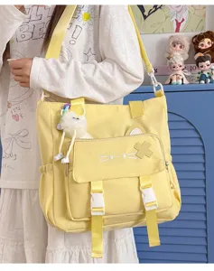 Cute yellow canvas crossbody bag with cat ears design, large capacity student shoulder bag.