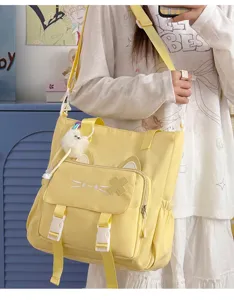 Cute canvas tote bag with cat ears and plush ball pendant, versatile crossbody shoulder bag.