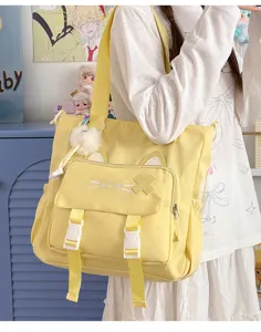Cute cat canvas shoulder bag large capacity casual student crossbody bag with plush pom-pom.