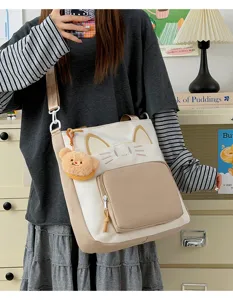 Canvas cat tote bag with cute bear pendant, large capacity crossbody shoulder bag for daily use.