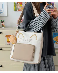 Canvas tote bag with cute cat ear embroidery, large capacity shoulder bag for daily commute.