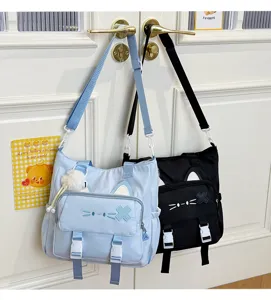 Detailed shot of cute cat ear shoulder bags hanging on door, showing pockets and straps.