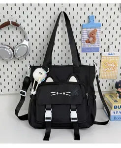 Detail shot of the cute black cat canvas shoulder bag with plush pendant and ears.