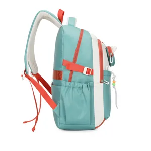 Side detail view of the green and white school backpack with orange straps and side pocket.