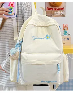 Detailed view of the casual solid color student backpack featuring front embroidery.