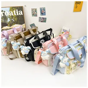 Cute student canvas shoulder bag detail showing multi-color options and bear pendants.