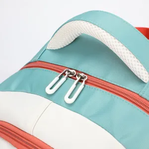 Backpack detail shot showing the breathable mesh handle and double metal zippers.