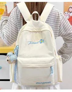 Casual white canvas backpack for women and students, lightweight daily school bag with cute pendant.