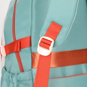 Close-up detail view of turquoise backpack showing orange adjustable strap and white buckle.