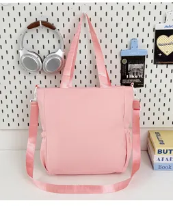 Bolso shopper de lona rosa con correa para el hombro y bolsillos para la escuela.