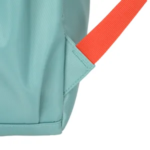 Detailed view of light blue nylon backpack strap attachment with vibrant orange webbing.