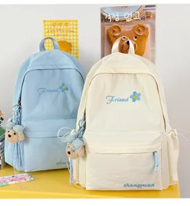 Japanese style solid color casual student backpack with cute bear pendant for daily use.