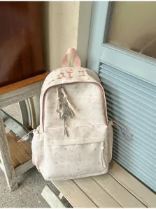 Detailed view of the pink star pattern backpack featuring gothic embroidery and a star pendant.