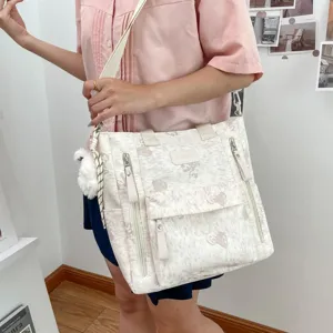 Korean style canvas multi-pocket backpack shoulder bag with cute fluffy charm for students.