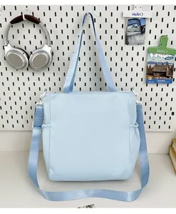 Casual light blue canvas shoulder bag, large capacity tote for student daily study and school use.