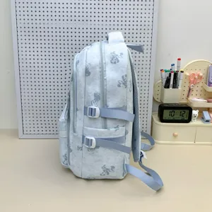 Light blue school backpack with cute bear print, multi-compartment student bookbag.