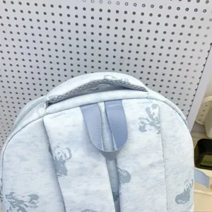 Blue student school backpack detail shot, cute bear print pattern, daily casual durable bag.