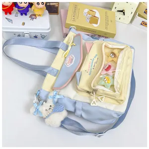 Cute canvas shoulder bag with transparent front pocket, large capacity student tote bag design.
