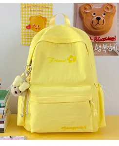 Cute solid color yellow canvas backpack for women and students, lightweight daily casual bookbag.