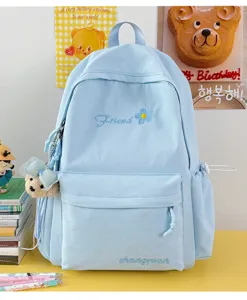 Light blue casual student backpack detail view featuring cute embroidery and lovely pendant.