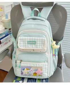 Large capacity plaid student backpack with transparent ita window and cute plush pendants for daily use.