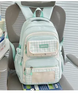 Mint green plaid student backpack detail, featuring transparent ita bag window and pocket.