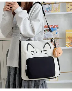 Cute cat canvas tote bag with contrast color design, large capacity for school and commuting.