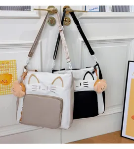 Detailed shot of the cat design colorblock tote bag, showing embroidered ears and plush bear.