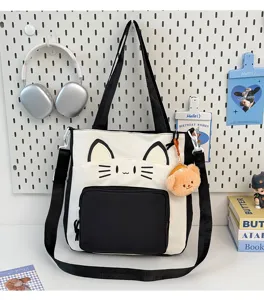 Cute cat face detail and color block design on large canvas tote bag for school use.