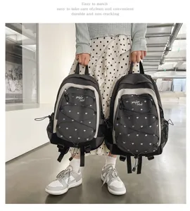 Detailed view of stylish grey heart-printed student backpack with practical bungee cords.
