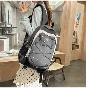Detail view of the sweet heart print backpack with elastic bungee cords for school commute.