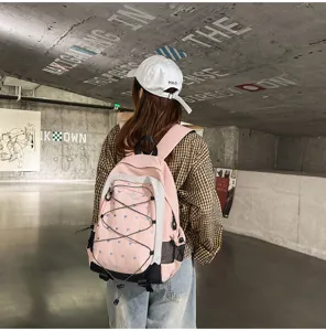 Pink and white heart print student backpack with bungee cord detail, ideal for daily campus commute.