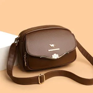 Detailed view of brown PU leather women crossbody bag with clover buckle and strap adjustment.