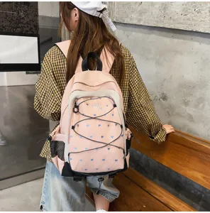 Pink and white heart print backpack for girls, stylish student school bag and casual daypack.