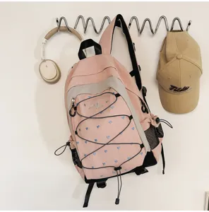 Pink and white sweet cool style heart printed backpack detail, featuring convenient side mesh pockets.