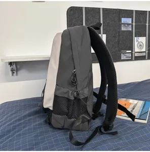 Side profile view of grey casual commuter backpack featuring convenient side mesh pockets.