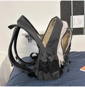 Detailed side view of a stylish grey and beige casual backpack with mesh pockets for daily use.