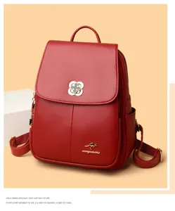 Detail view of red soft leather women backpack showcasing exquisite metal clover clasp.