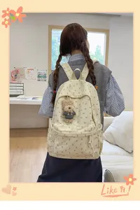 Sweet bow corduroy backpack for women, large capacity student school bag with cute bear pendant.