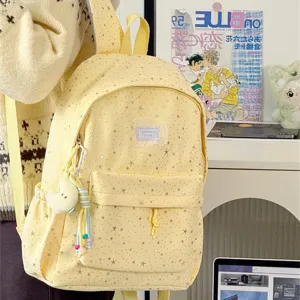 Detailed view of the cute yellow star print backpack with spacious interior and front pocket.