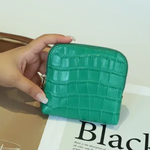 Green crocodile pattern genuine leather coin purse and card holder with zipper closure.