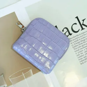 Close-up view of a purple crocodile embossed leather coin purse with silver zipper detail.