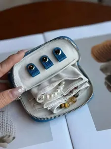 Close-up view of the blue crocodile pattern leather jewelry storage box showing inner compartments.