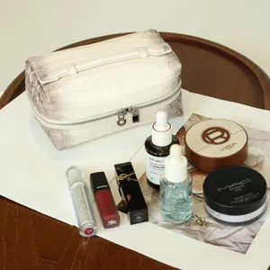 White crocodile textured travel makeup bag with double zippers and spacious storage capacity.